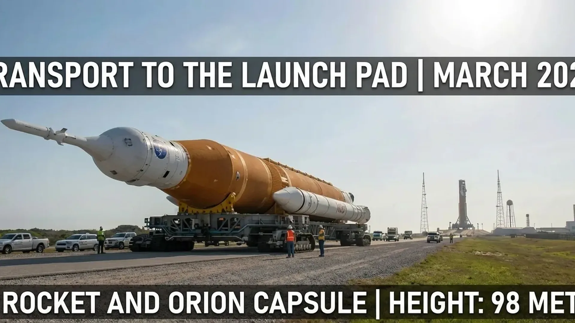 SLS rocket emerging from Vehicle Assembly Building during rollout procedures