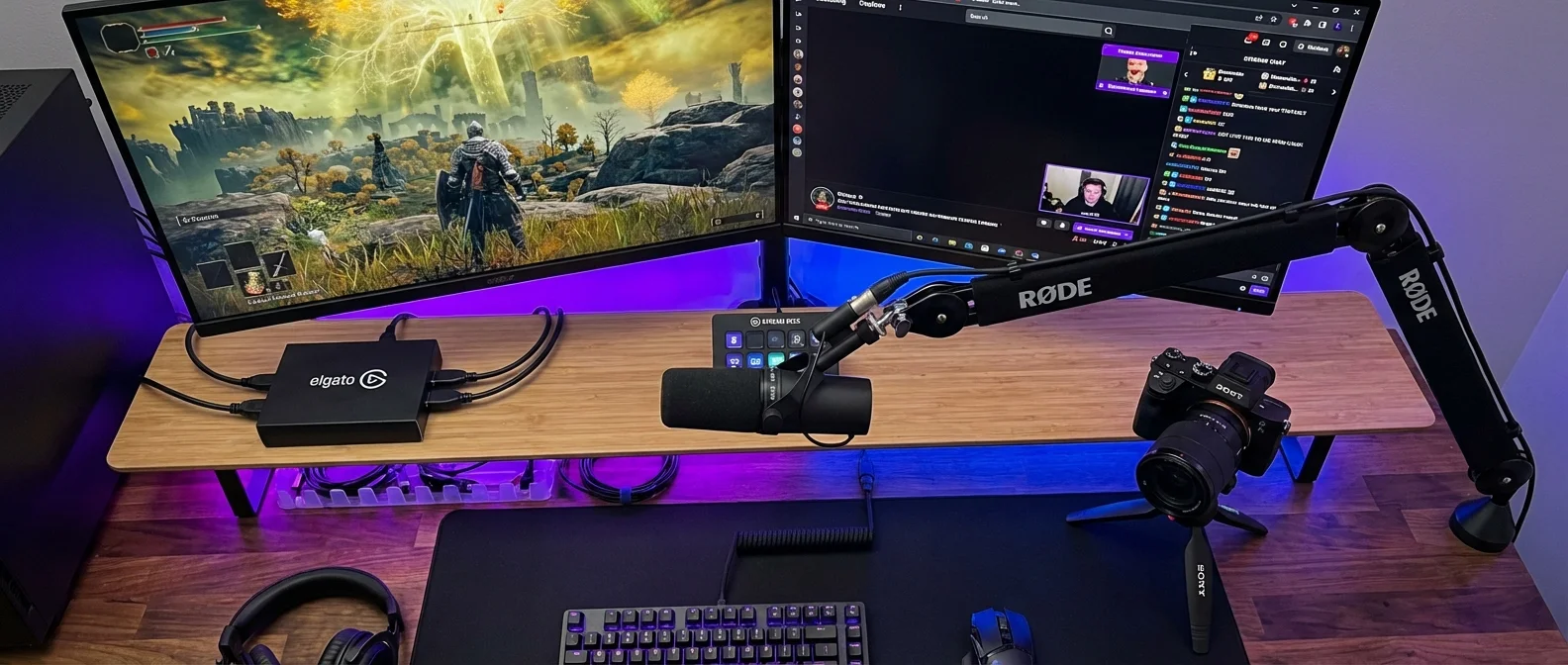 Complete gaming streaming setup with microphone, camera, lighting and Stream Deck equipment arranged on desk