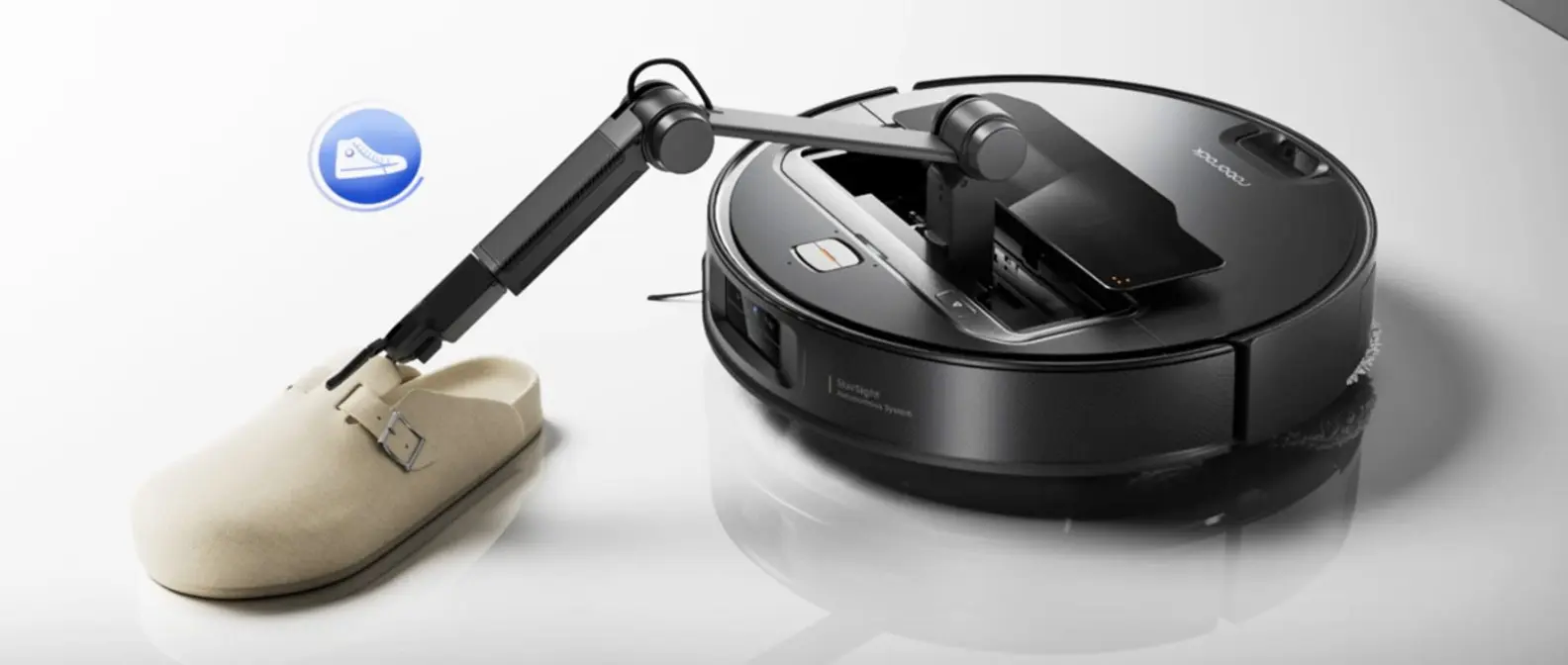 Roborock Saros Z70 robot vacuum featuring OmniGrip robotic arm picking up objects from floor